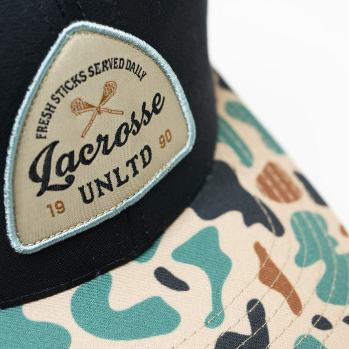 Camo Arrow Lacrosse Hat zoomed in on logo