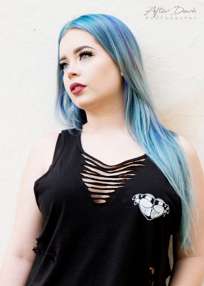 Female model wearing a tattoo style butt heart logo on black tank top.