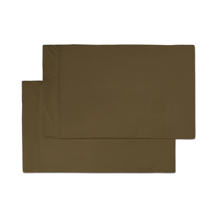 A pair of forest green jersey knit pillowcases with a hem png flat lay image