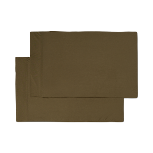 A pair of forest green jersey knit pillowcases with a hem png flat lay image