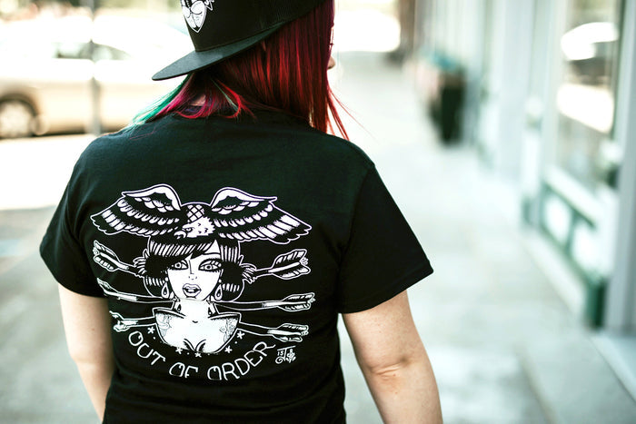 Female model wearing tattoo style lady head shirt.