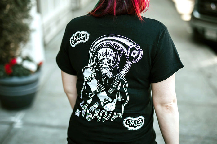 Female model wearing tattoo style skateboard reaper t-shirt.