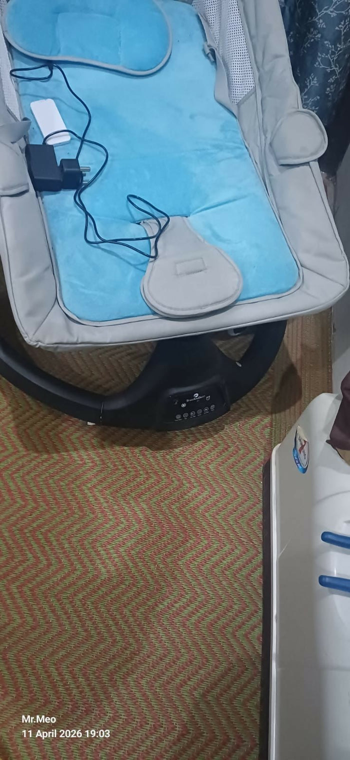 Electric swing and rocker for babies with gentle soothing motion, cushioned seat, secure harness, calming design, and comfortable support for rest and relaxation.